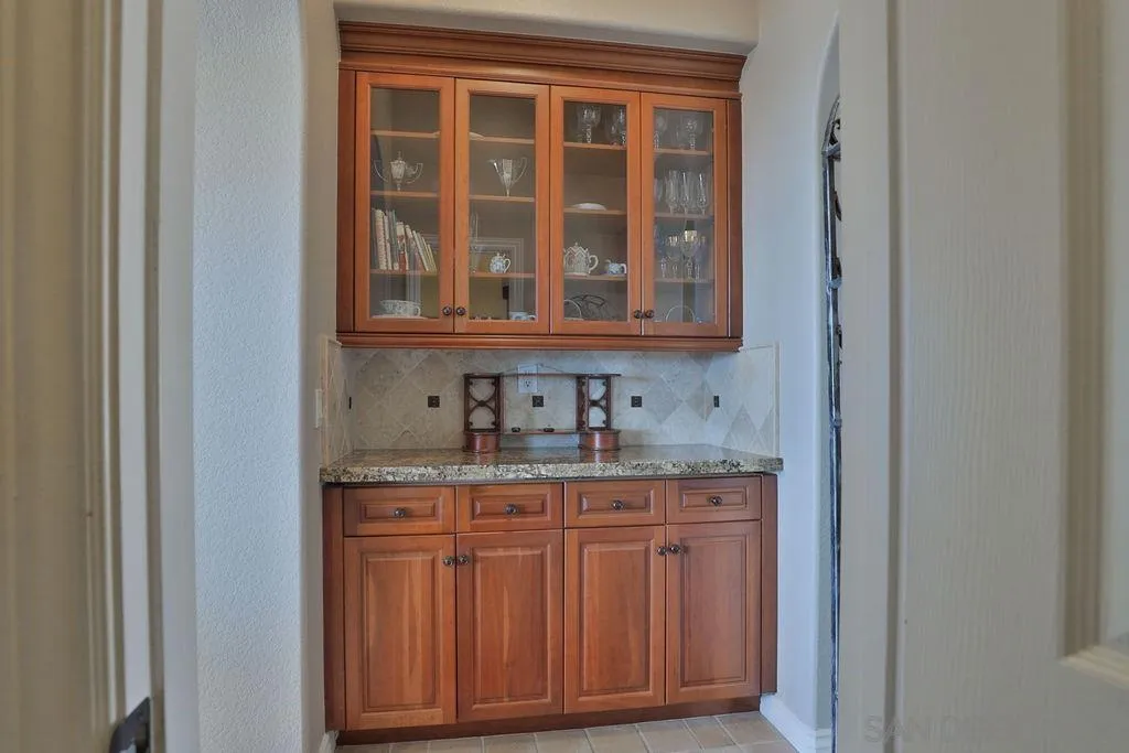 1375 Ravean Court Encinitas, CA 92024 - Photo 36 of 73 a bathroom with a granite countertop sink and a cabinet