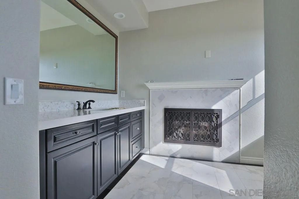 1375 Ravean Court Encinitas, CA 92024 - Photo 54 of 73 a bathroom with a sink double vanity and a mirror