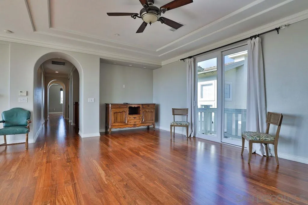 1375 Ravean Court Encinitas, CA 92024 - Photo 56 of 73 a view of empty room with wooden floor and fan