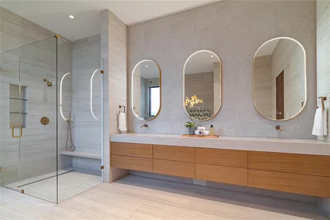 a bathroom with double vanity sinks and a mirror