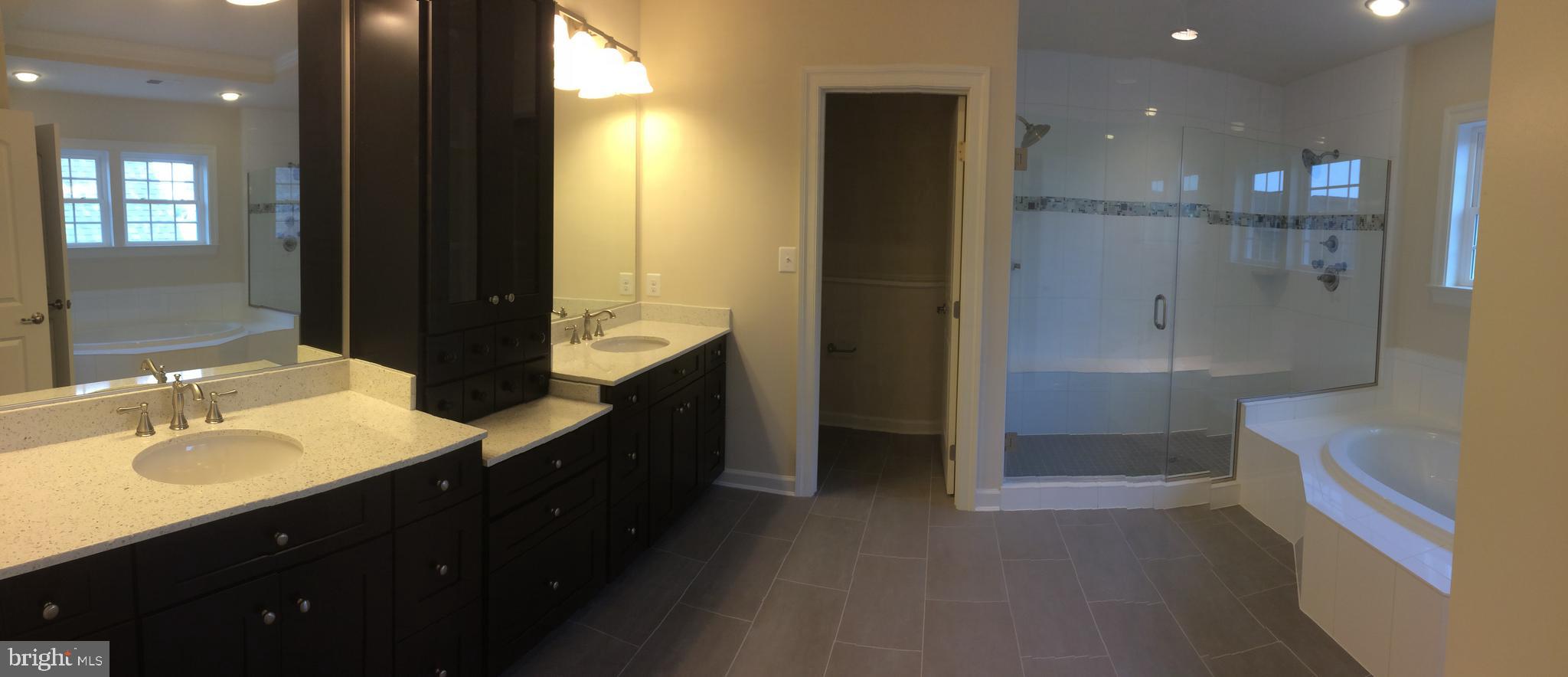 515 Parkland Road Eldersburg, MD 21784 - Photo 8 of 18 a bathroom with a double vanity sink a toilet and shower