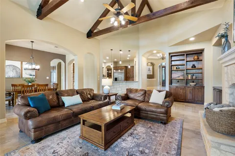 a living room with furniture a rug and a chandelier