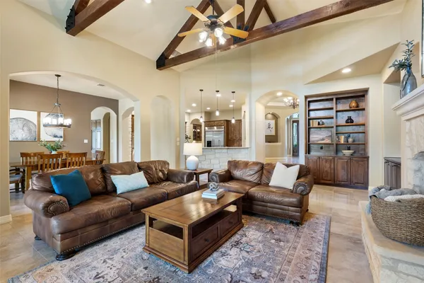 a living room with furniture a rug and a chandelier