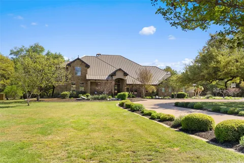 a view of a house with a yard and garage