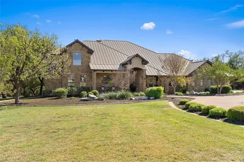 a view of a house with swimming pool and a yard