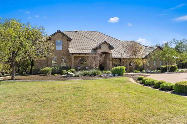 a view of a house with swimming pool and a yard
