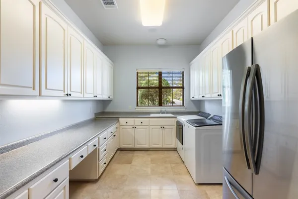 a kitchen with stainless steel appliances granite countertop a refrigerator sink and stove