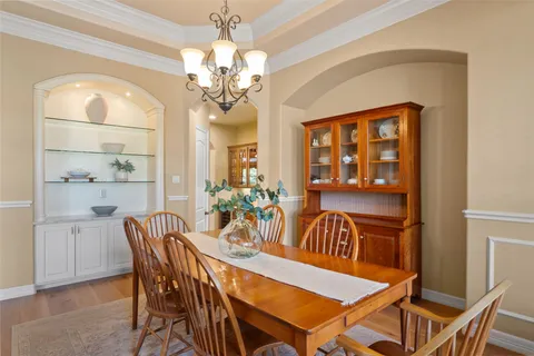 a view of a dining room with furniture and chandelier