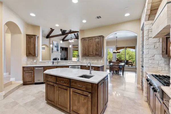 a kitchen with a sink stove and cabinets