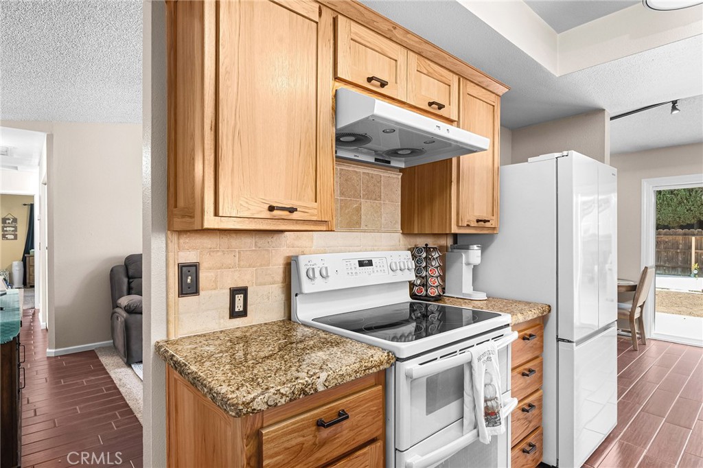 3985 Front Street Chico, CA 95928 - Photo 13 of 55 a kitchen with stainless steel appliances granite countertop a sink stove and refrigerator