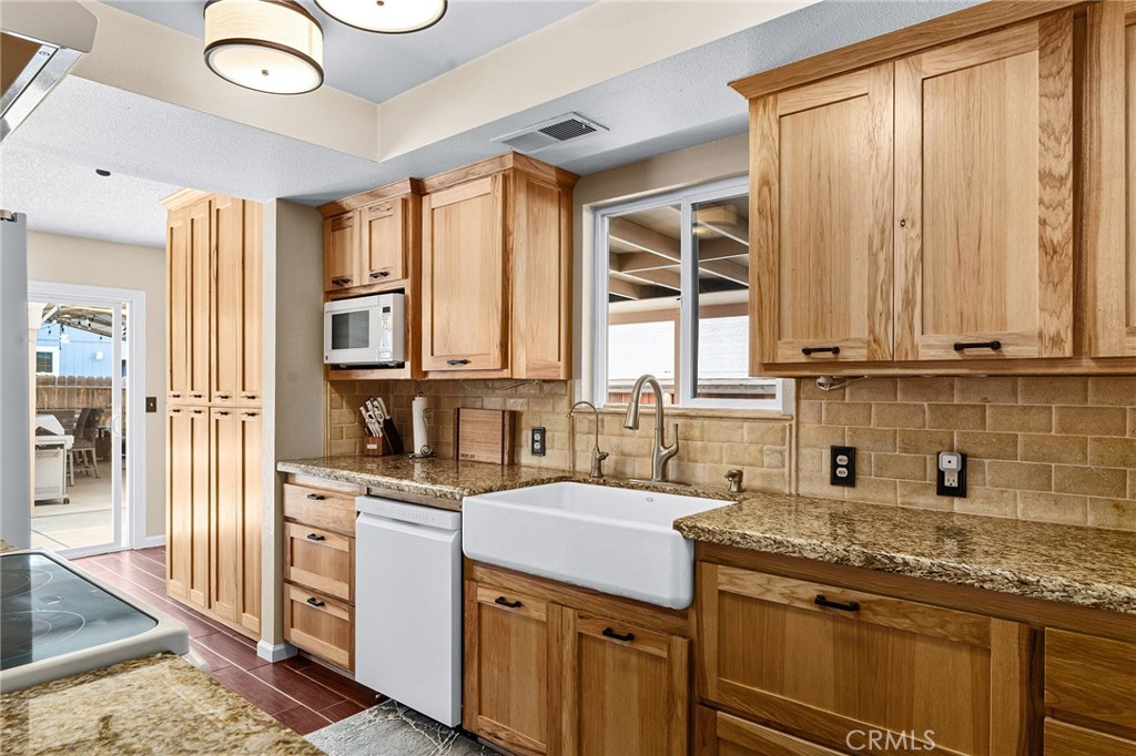 3985 Front Street Chico, CA 95928 - Photo 6 of 55 a kitchen with stainless steel appliances granite countertop a sink and a stove next to a window