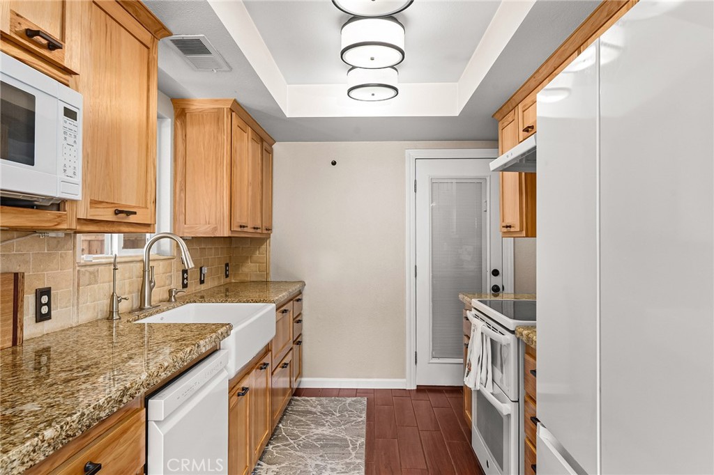 3985 Front Street Chico, CA 95928 - Photo 10 of 55 a kitchen with granite countertop a sink a counter top space and cabinets