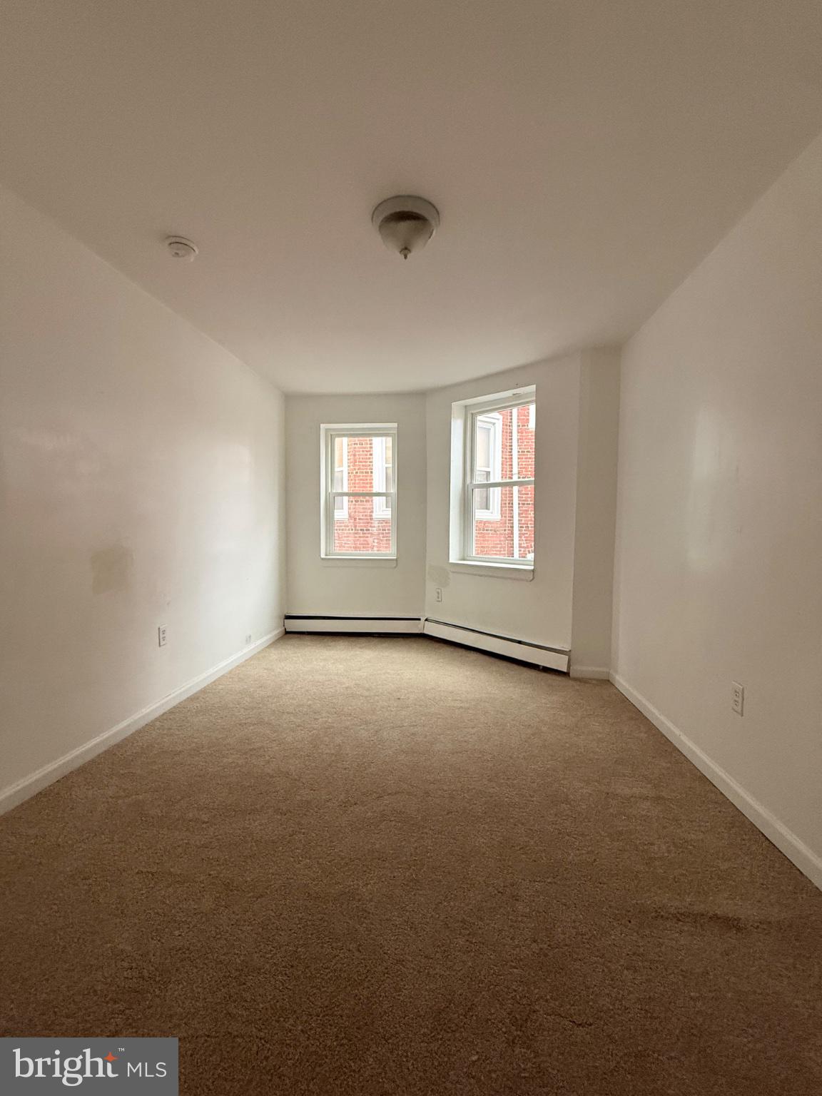822 Wynnewood Road, Unit 2 Philadelphia, PA 19151 - Photo 8 of 15 an empty room with windows