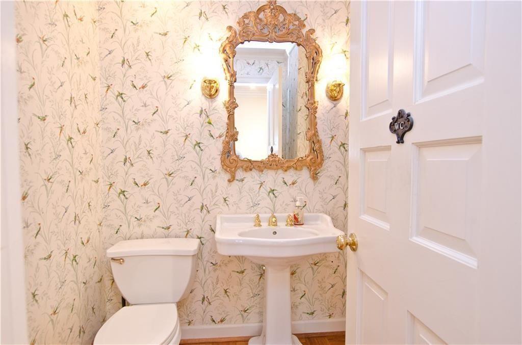 2734 Peachtree Road Northwest, Unit C404 Atlanta, GA 30305 - Photo 11 of 19 a bathroom with a toilet sink and mirror