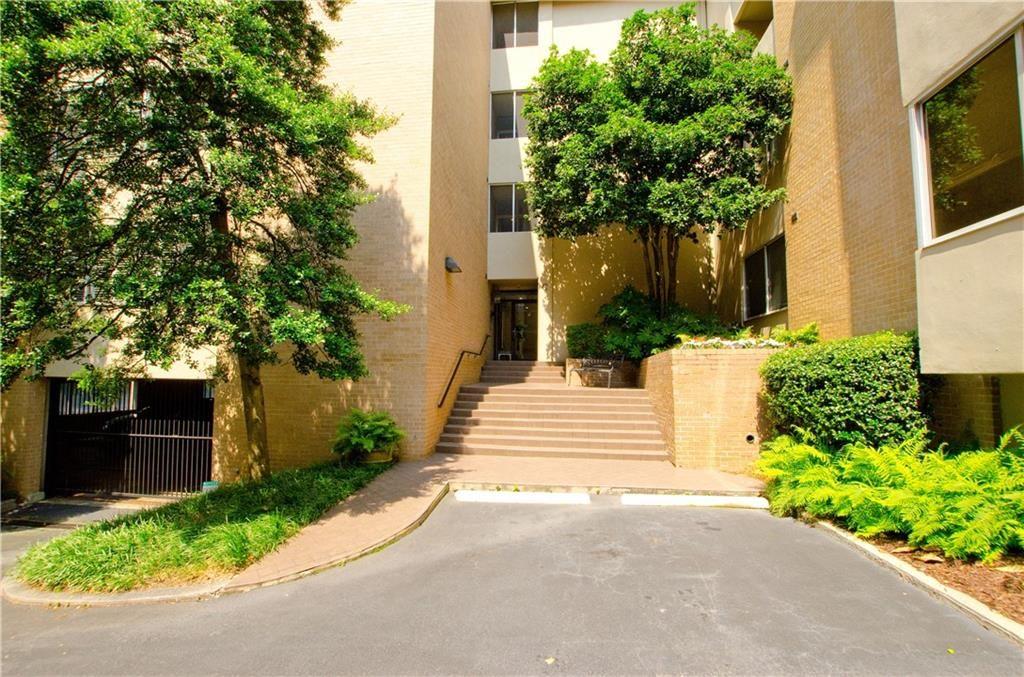 2734 Peachtree Road Northwest, Unit C404 Atlanta, GA 30305 - Photo 2 of 19 a front view of a house with plants and trees