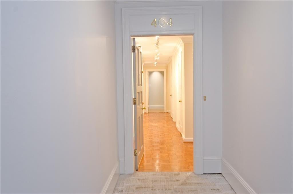2734 Peachtree Road Northwest, Unit C404 Atlanta, GA 30305 - Photo 3 of 19 an empty room with wooden floor and a window