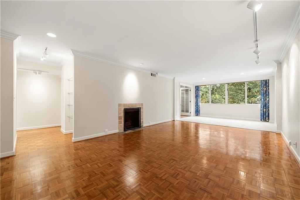 2734 Peachtree Road Northwest, Unit C404 Atlanta, GA 30305 - Photo 6 of 19 a view of an empty room with window and wooden floor
