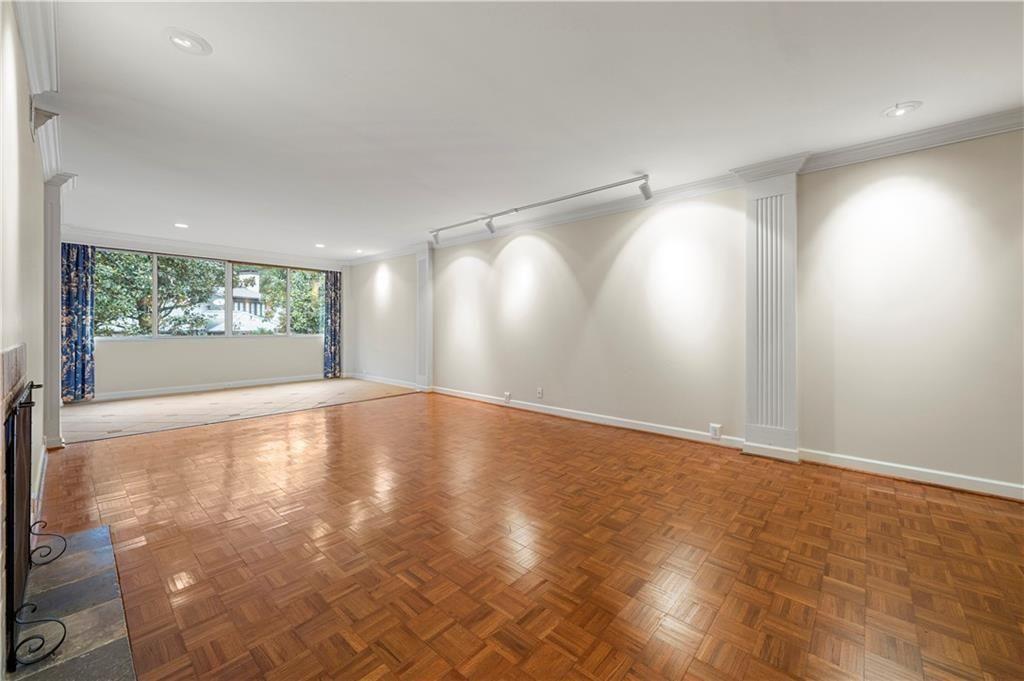 2734 Peachtree Road Northwest, Unit C404 Atlanta, GA 30305 - Photo 7 of 19 a view of empty room with wooden floor and fan