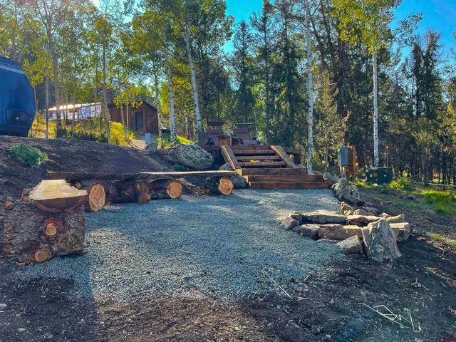 a view of a swimming pool with a yard and sitting area