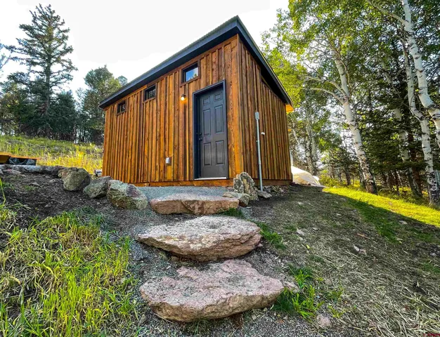 a view of a house with backyard and sitting area