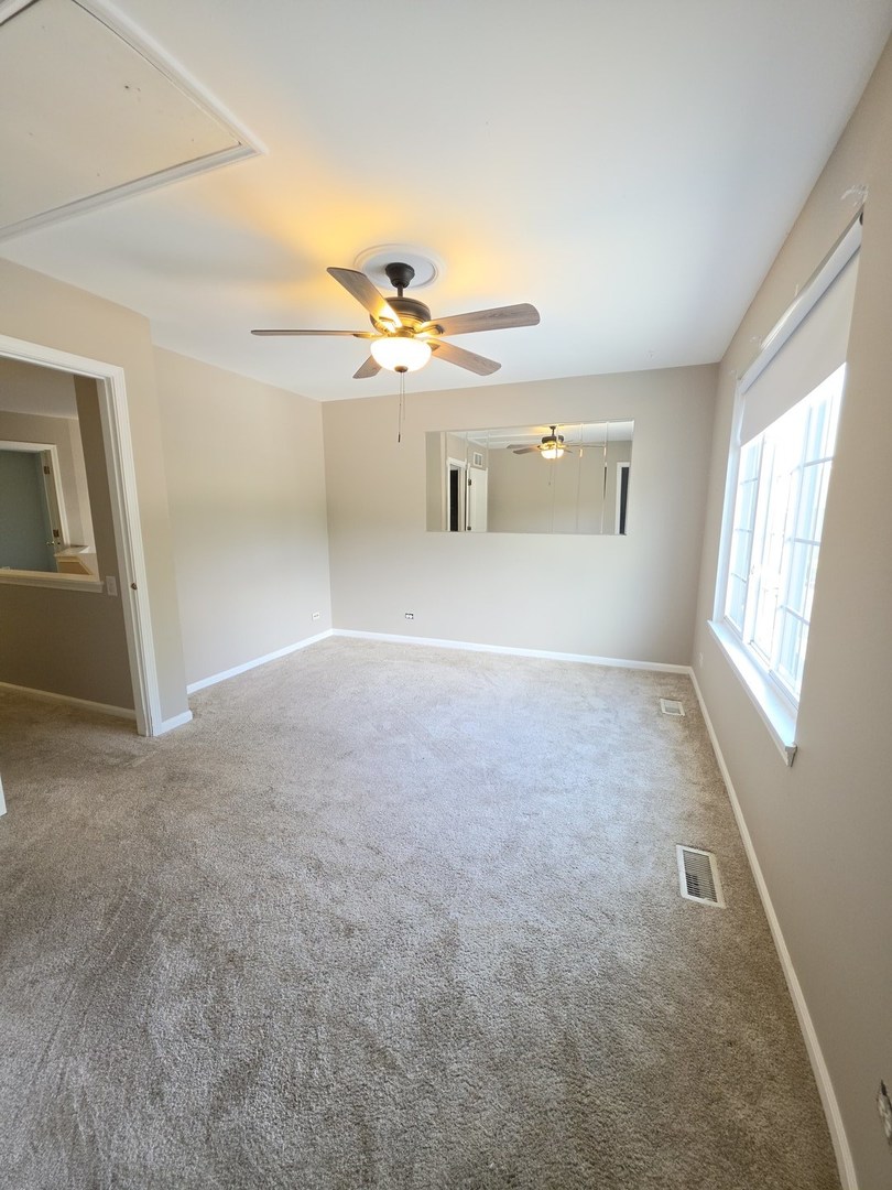 407 Spaulding Road, Unit 407 Bartlett, IL 60103 - Photo 4 of 25 a view of a livingroom with a ceiling fan
