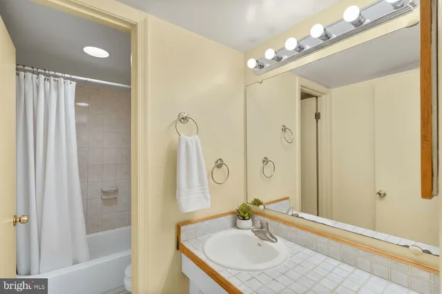 a bathroom with a sink double vanity granite tub and shower