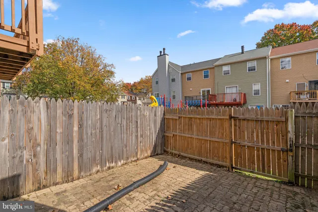 a view of a house with a wooden fence