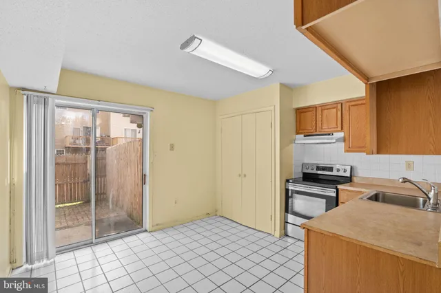 a kitchen that has a sink and a stove