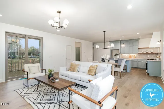 a living room with furniture and a chandelier