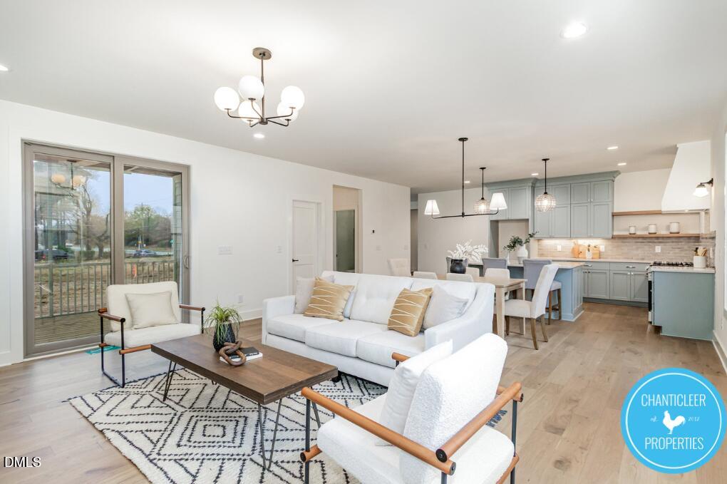 a living room with furniture and a chandelier