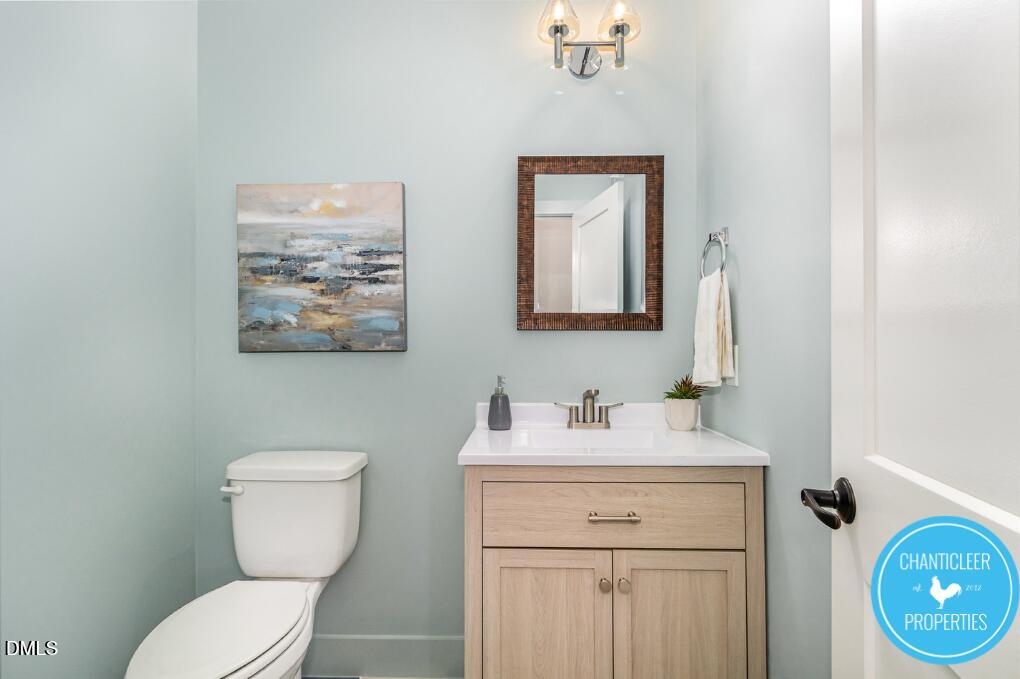 2307 Broad Street Durham, NC 27704 - Photo 16 of 29 a bathroom with a toilet sink and mirror