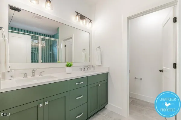 a bathroom with a double vanity sink and a mirror