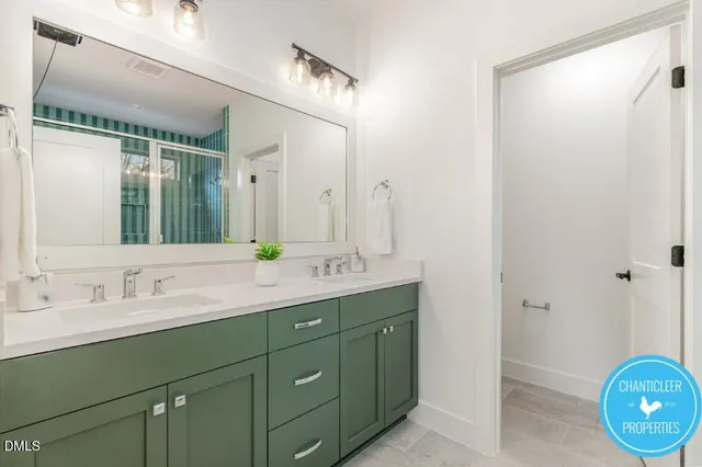 a bathroom with a double vanity sink and a mirror