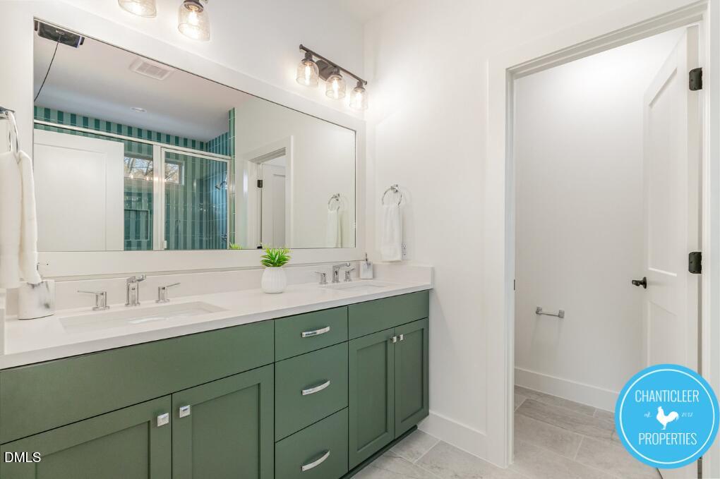 2307 Broad Street Durham, NC 27704 - Photo 19 of 29 a bathroom with a double vanity sink and a mirror