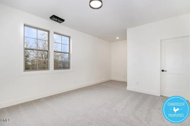 an empty room with windows and entrance