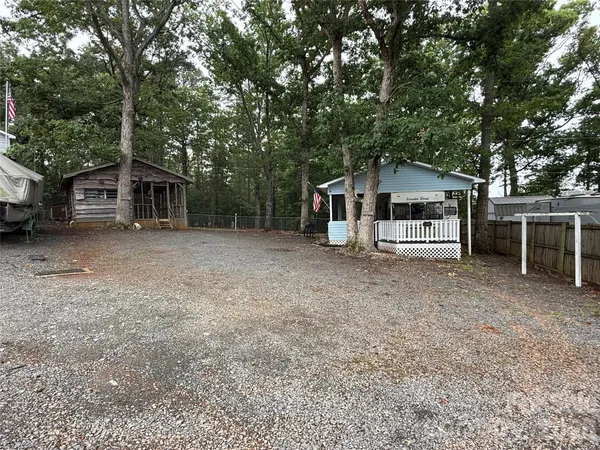 a view of a house with a backyard