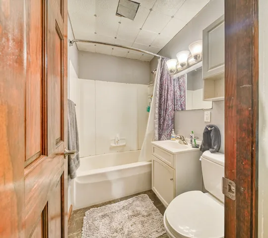 a bathroom with a toilet a sink and bathtub