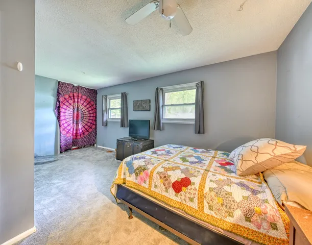 a bedroom with a bed and window