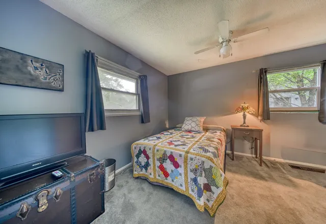a bedroom with a bed table and window