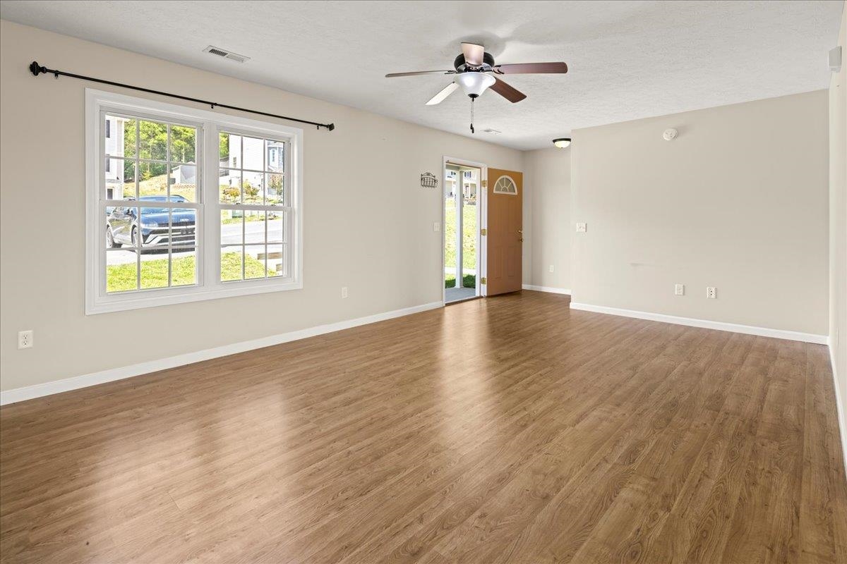 3265 Hebron Court Harrisonburg, VA 22801 - Photo 5 of 30 a view of an empty room with a window and wooden floor