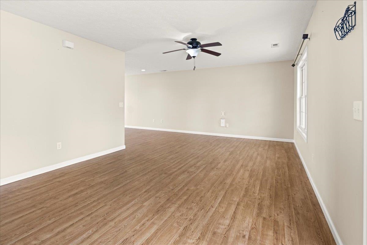 3265 Hebron Court Harrisonburg, VA 22801 - Photo 7 of 30 an empty room with wooden floor fan and windows