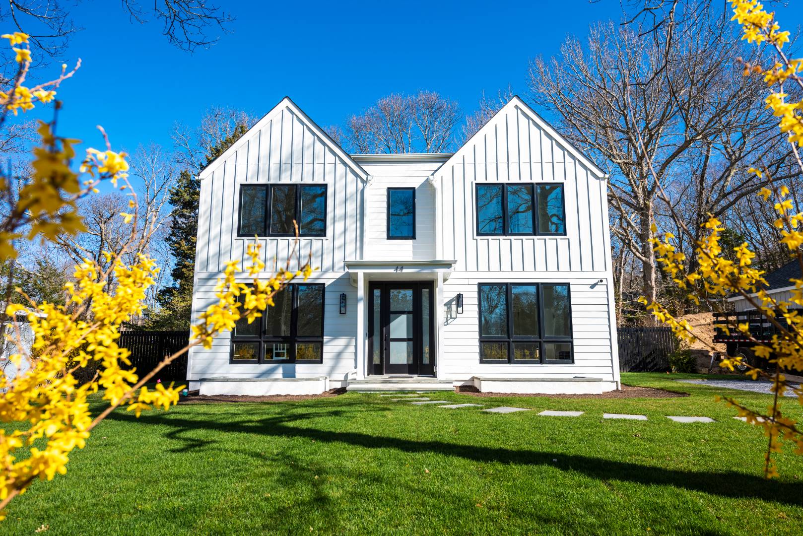 a front view of house with a garden