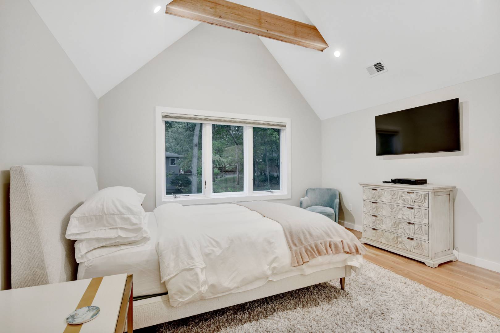 44 Richards Drive Sag Harbor, NY 11963 - Photo 21 of 37 a bedroom with a bed and a flat screen tv