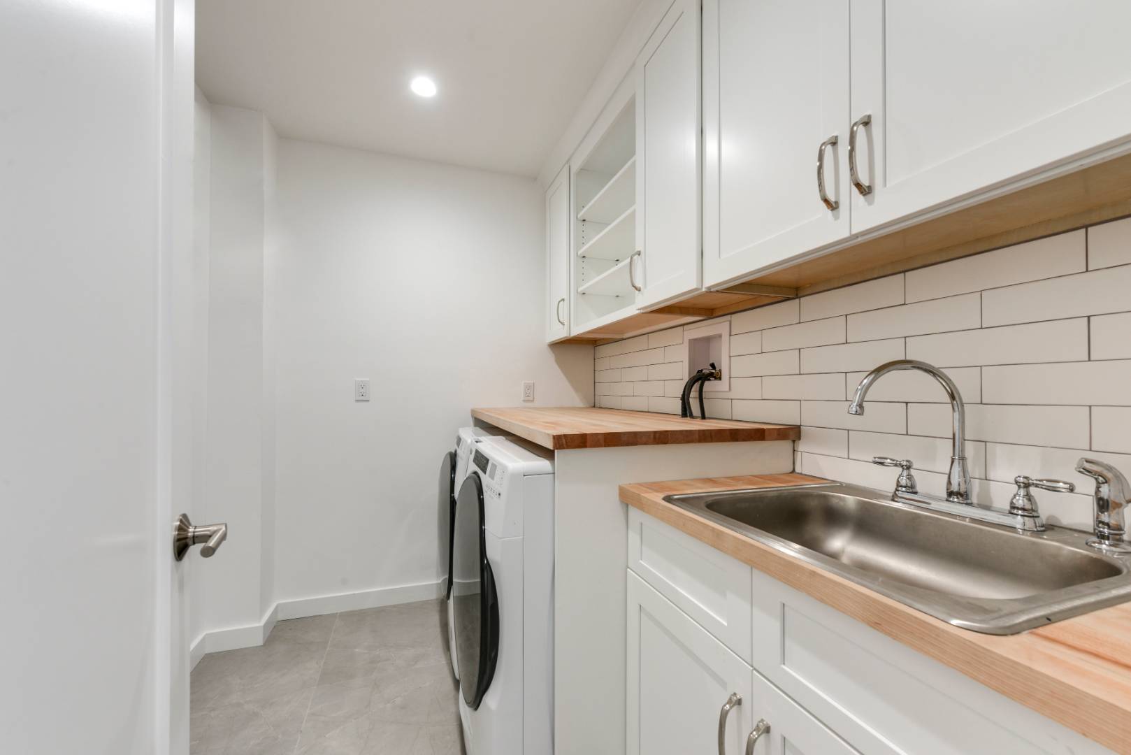 44 Richards Drive Sag Harbor, NY 11963 - Photo 31 of 37 a kitchen with a sink and cabinets