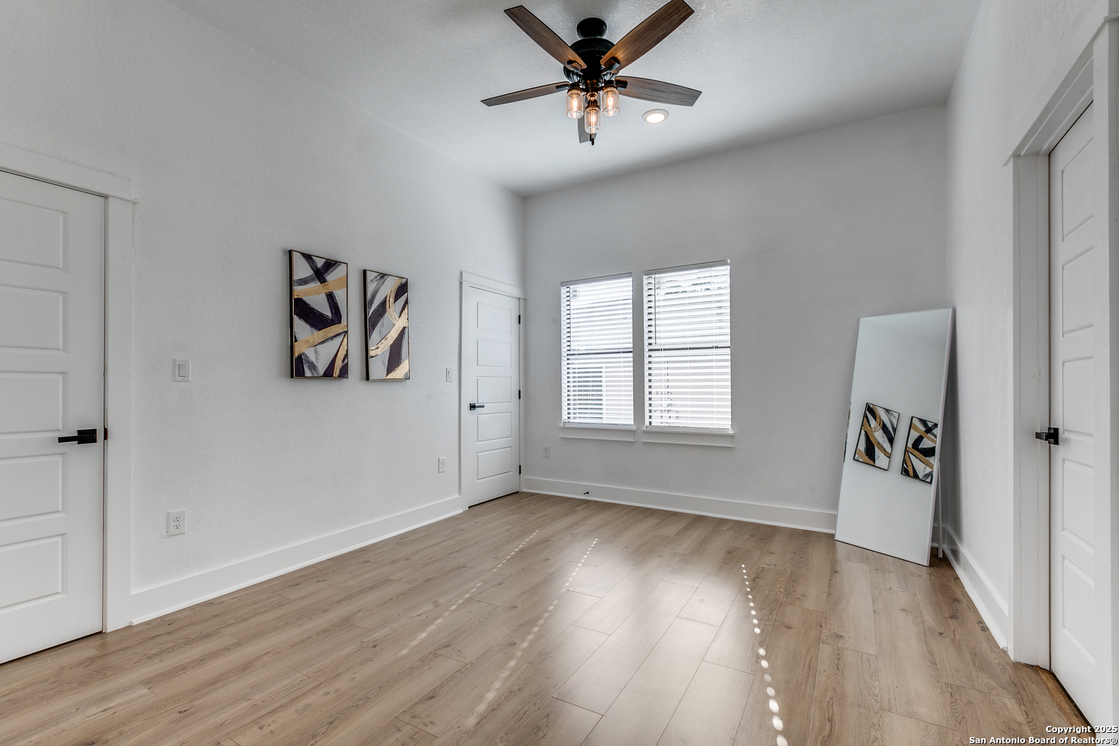 505 Rigsby Avenue San Antonio, TX 78210 - Photo 17 of 29 wooden floor in an empty room with a window