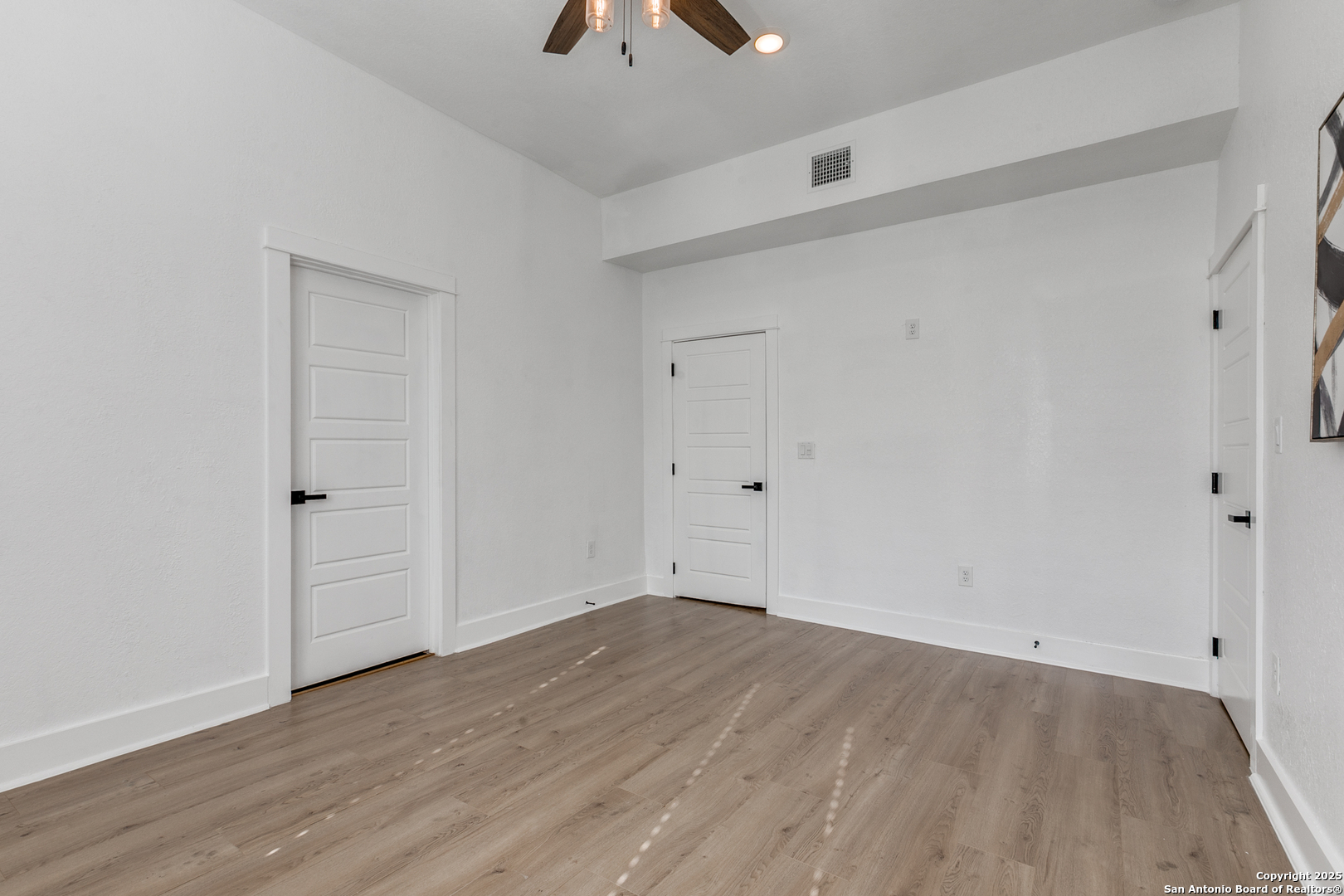 505 Rigsby Avenue San Antonio, TX 78210 - Photo 18 of 29 a view of an empty room with wooden floor and closet