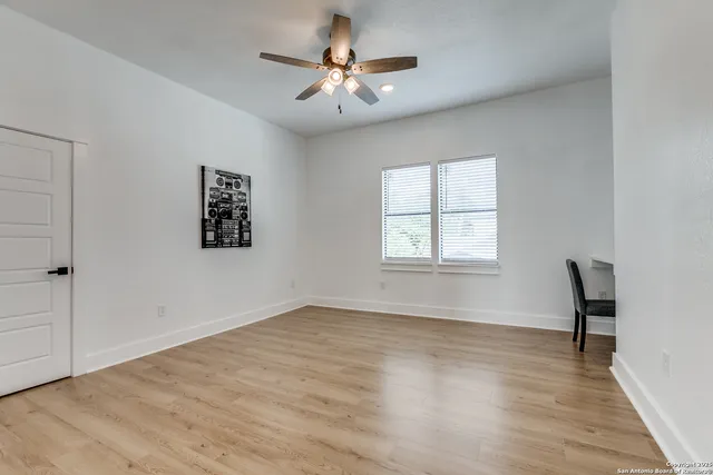wooden floor in an empty room with a window