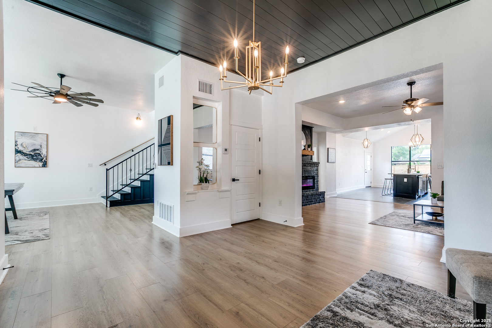 505 Rigsby Avenue San Antonio, TX 78210 - Photo 7 of 29 a view of a livingroom with wooden floor and a ceiling fan