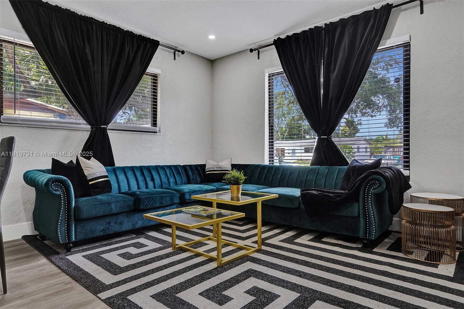 1324 Northeast 151st Street, Unit 1324 Miami, FL 33162 - Photo 1 of 23 a living room with furniture a fireplace and a large window