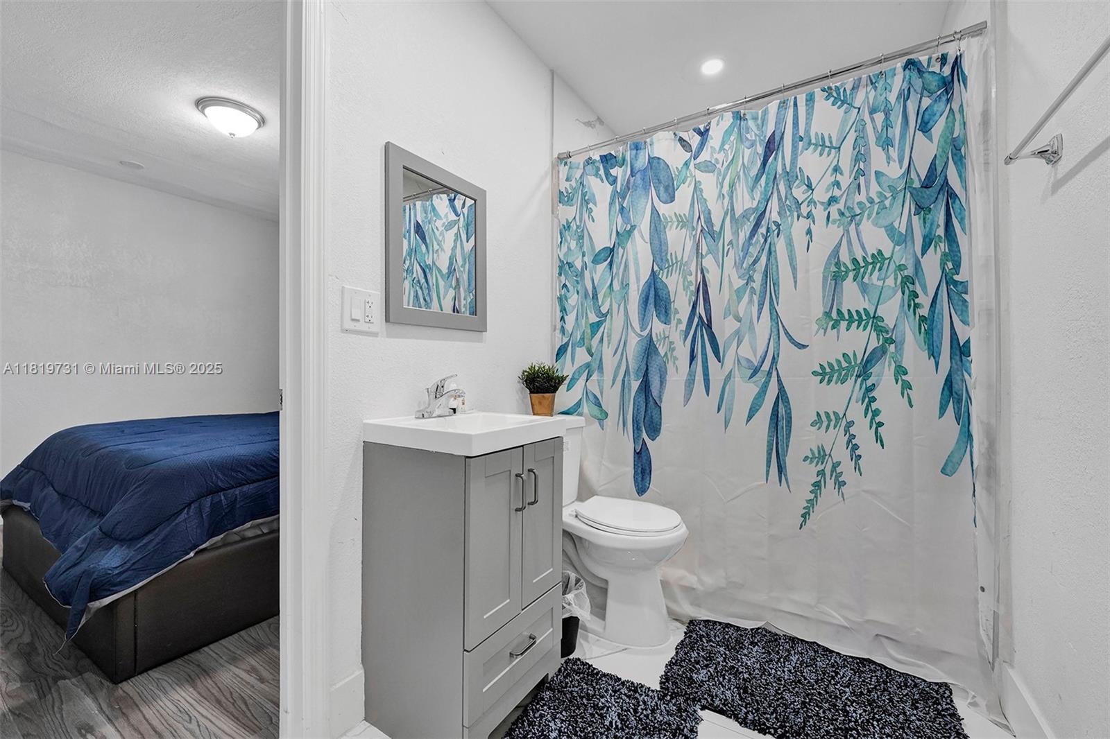 1324 Northeast 151st Street, Unit 1324 Miami, FL 33162 - Photo 11 of 23 a bathroom with a sink toilet and shower